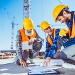construction-workers-discussing-building-plans